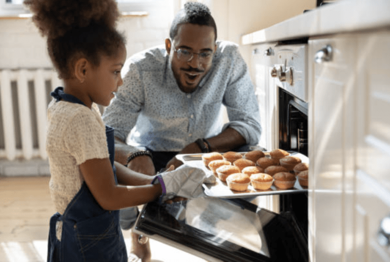 A Dad and Daughter amazed at Well Cooked Cupcakes from a Built-in Newmatic Oven