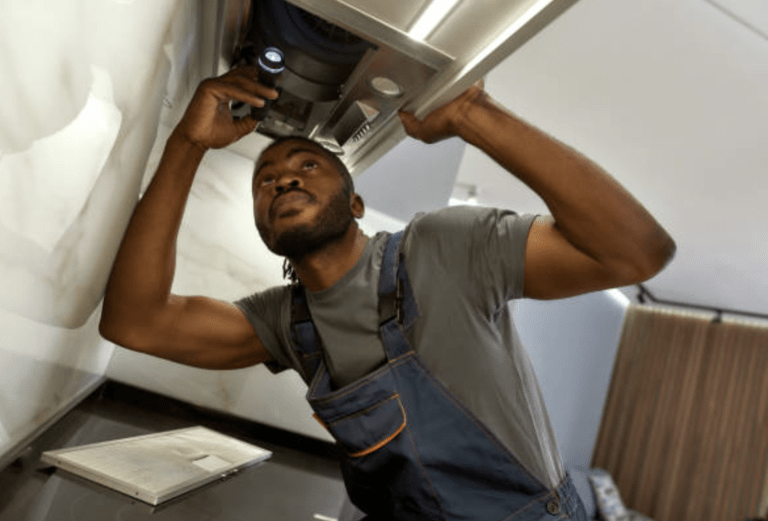 Worker fixing a chimney hood.