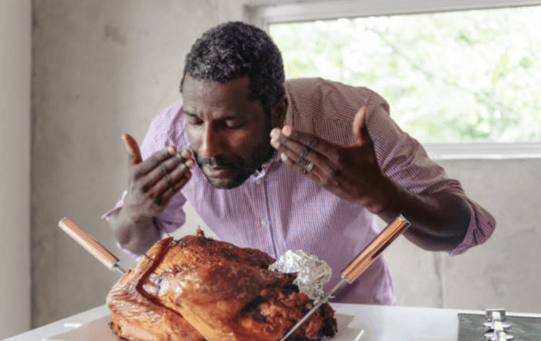 A Man Pleased by the Aromatic Smell of Chicken Grilled with Newmatic Built-in Oven