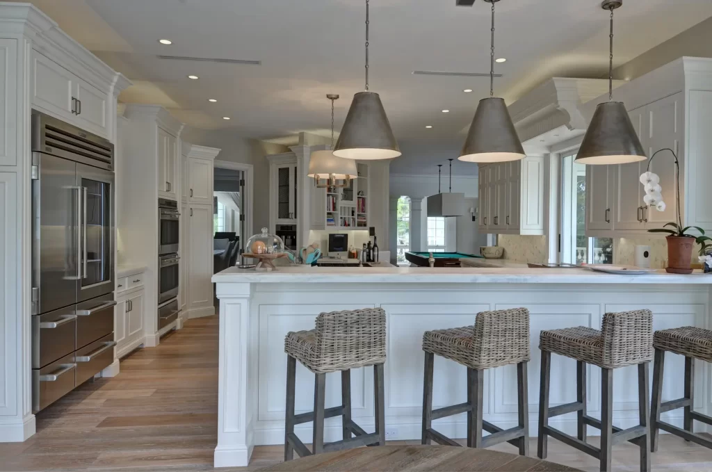 An Island Kitchen Design with Inbuilt Fridge, Ovens, and Countertop Appliances